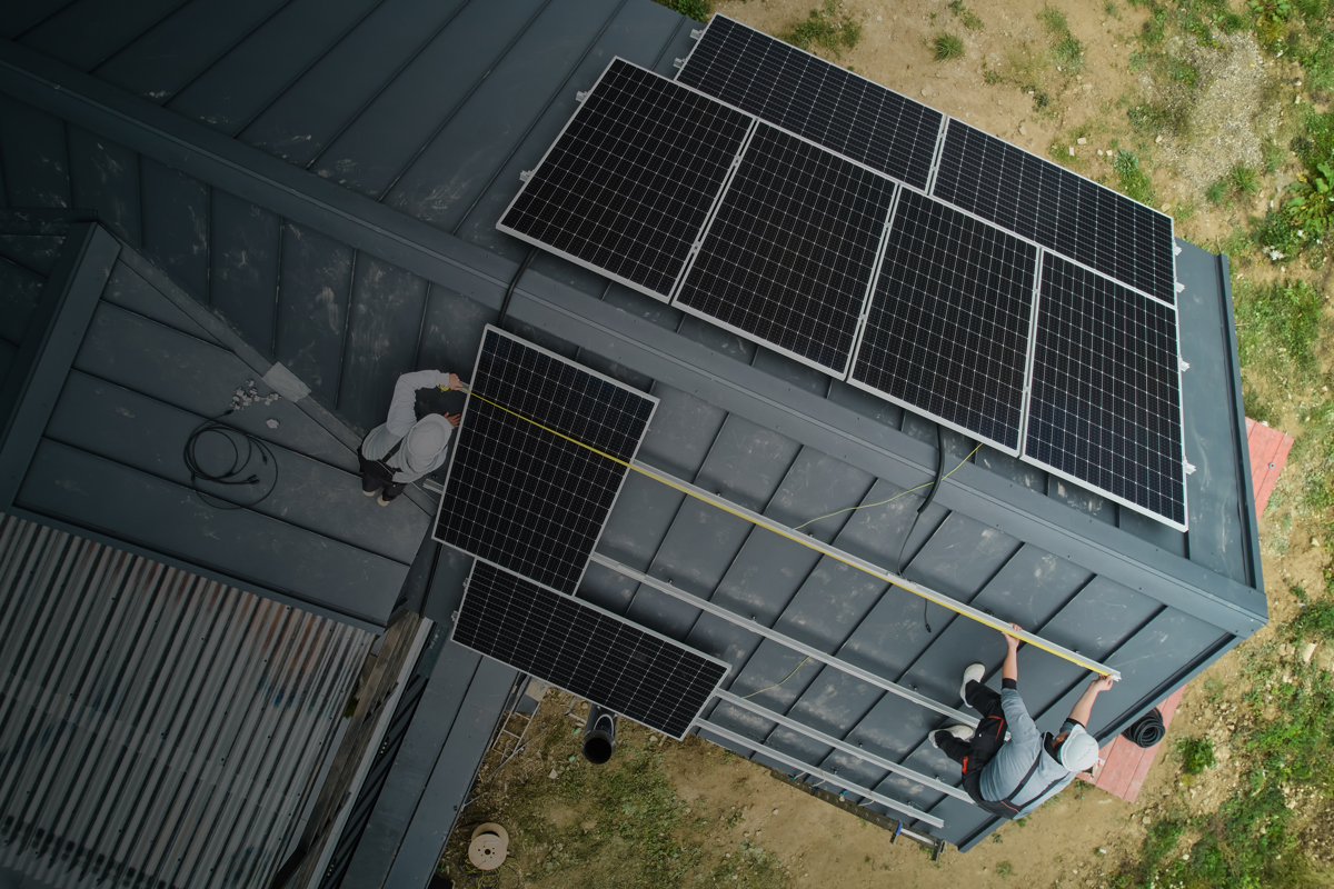 Man Worker Mounting Solar Panels On Roof Of House Edit